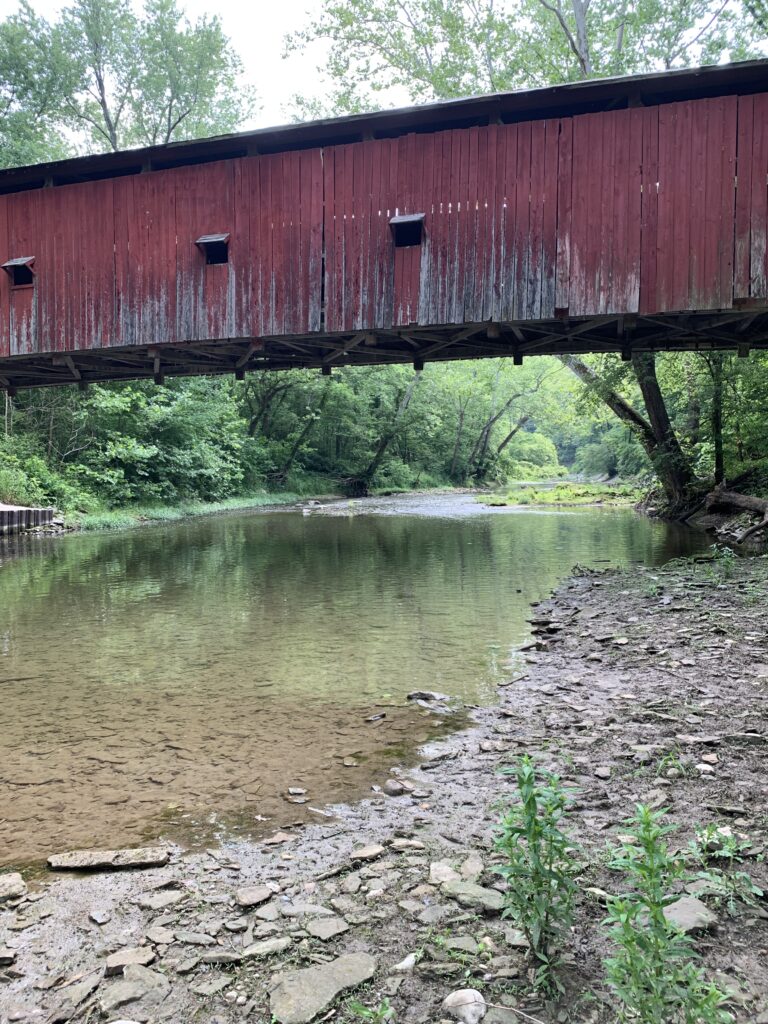 View of the river under a covered bridge