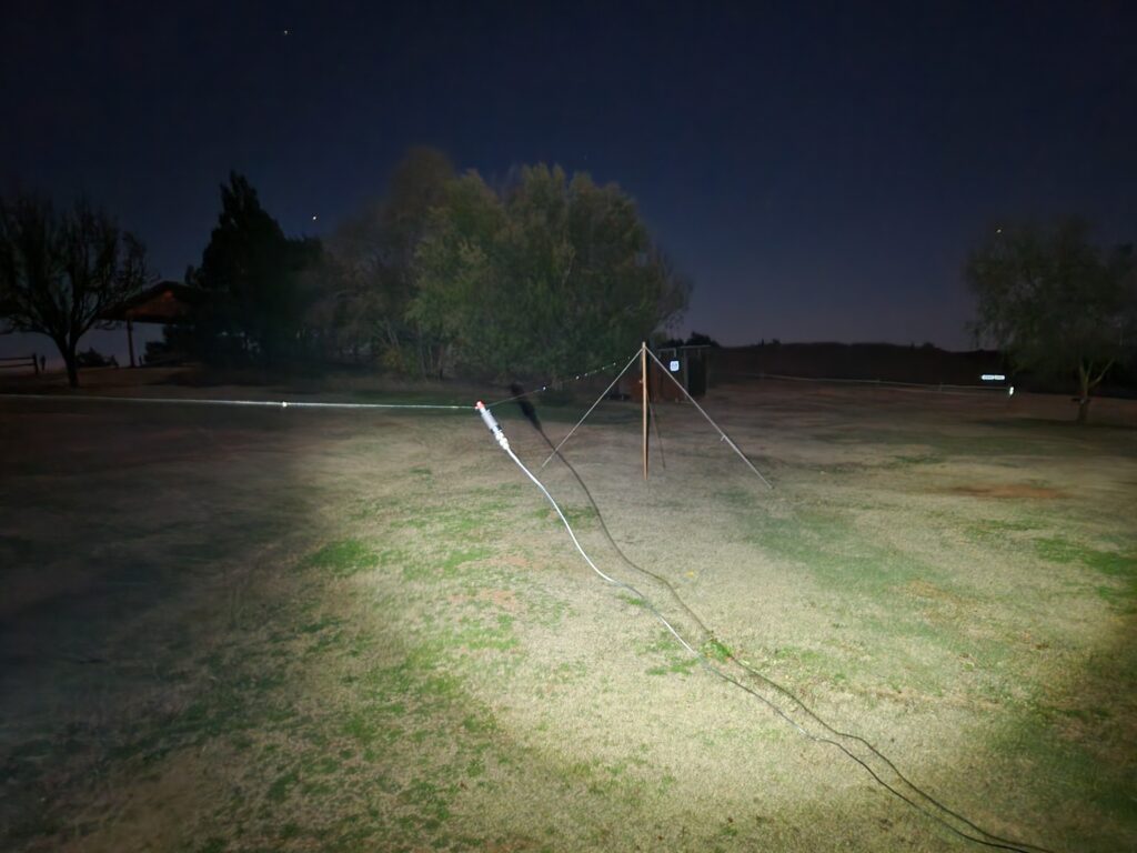 A 40 meter band dipole slung between two guyed wooden poles